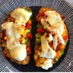 Cheese grilled open sandwich bread pizza topped with peppers, tomatoes, egg and cheese