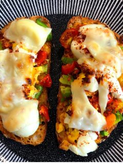 Cheese grilled open sandwich bread pizza topped with peppers, tomatoes, egg and cheese
