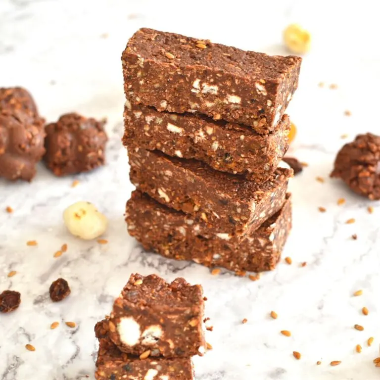 No-Bake Makhana Chocolate Energy Bars stacked up on a white board.