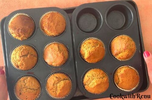Eggless Vanilla Cupcakes just out of oven and seen in muffin trays.