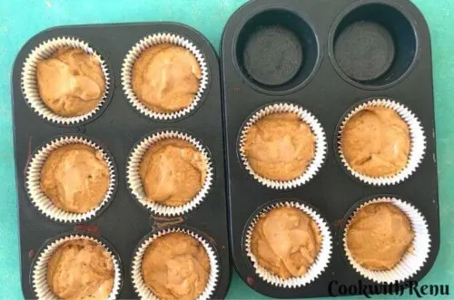 Eggless Vanilla Cupcakes ready to be baked in muffin trays.