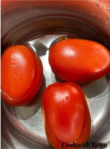 Tomatoes added in a pot of water.