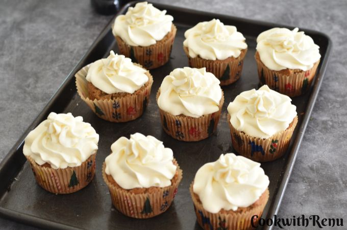 A tray of eggless and Vegan Vanilla Cupcakes on a grey board.