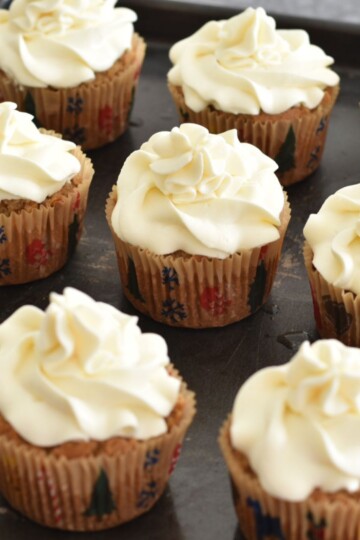 A tray of eggless and Vegan Vanilla Cupcakes on a grey board.