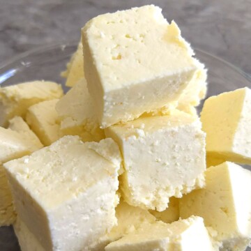 Homemade Paneer cubes in a glass bowl.