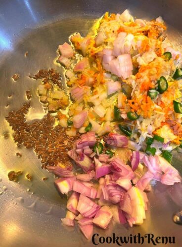 Adding of onion, garlic, giner, turmeric and green chili in oil
