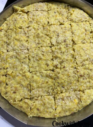 Gluten-free millet dhokla ready and cut into pieces in a steel plate