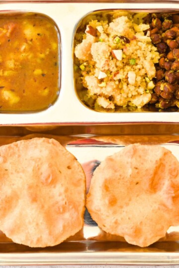 Navratri Ashtami /NavamiThali in a steel plate, with puri, halwa, channa, and aloo sabji.