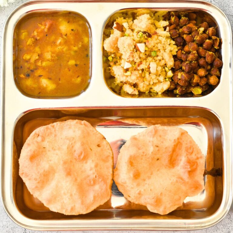 Navratri Ashtami /NavamiThali in a steel plate, with puri, halwa, channa, and aloo sabji.