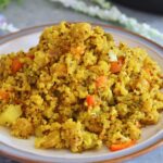 Instant Pot Quinoa Soya Vegetable Pulao served in a white plate with grey and brown lining.