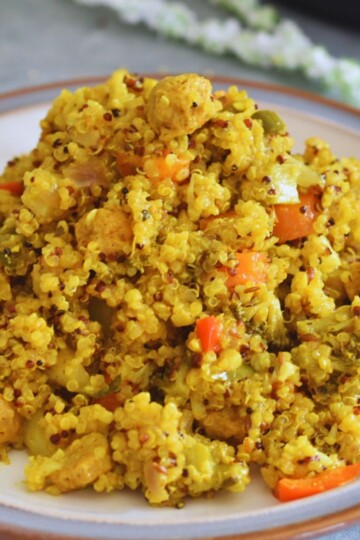 Instant Pot Quinoa Soya Vegetable Pulao served in a white plate with grey and brown lining.