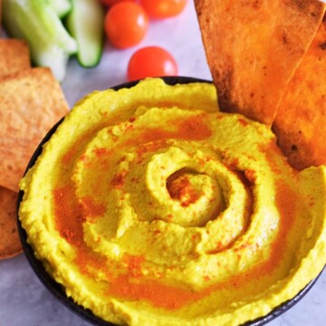 Healthy turmeric hummus served with salads and nacho chips made using wrap.