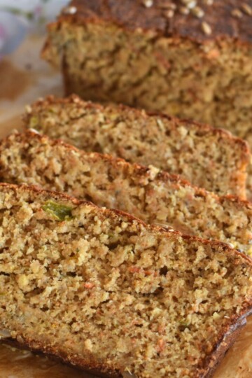 Slices of Roasted Pepper and Onion Spelt Flour Bread seen in the picture on a white parchment paper.