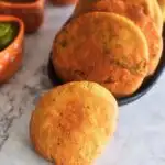 Front view of Air Fryer Baked whole wheat kachori. in front and behind some fried kachori.