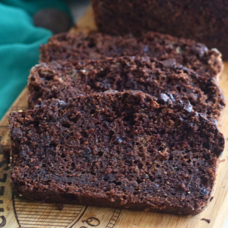 Slices of Whole Wheat Zucchini Chocolate Bread on a cutting board.