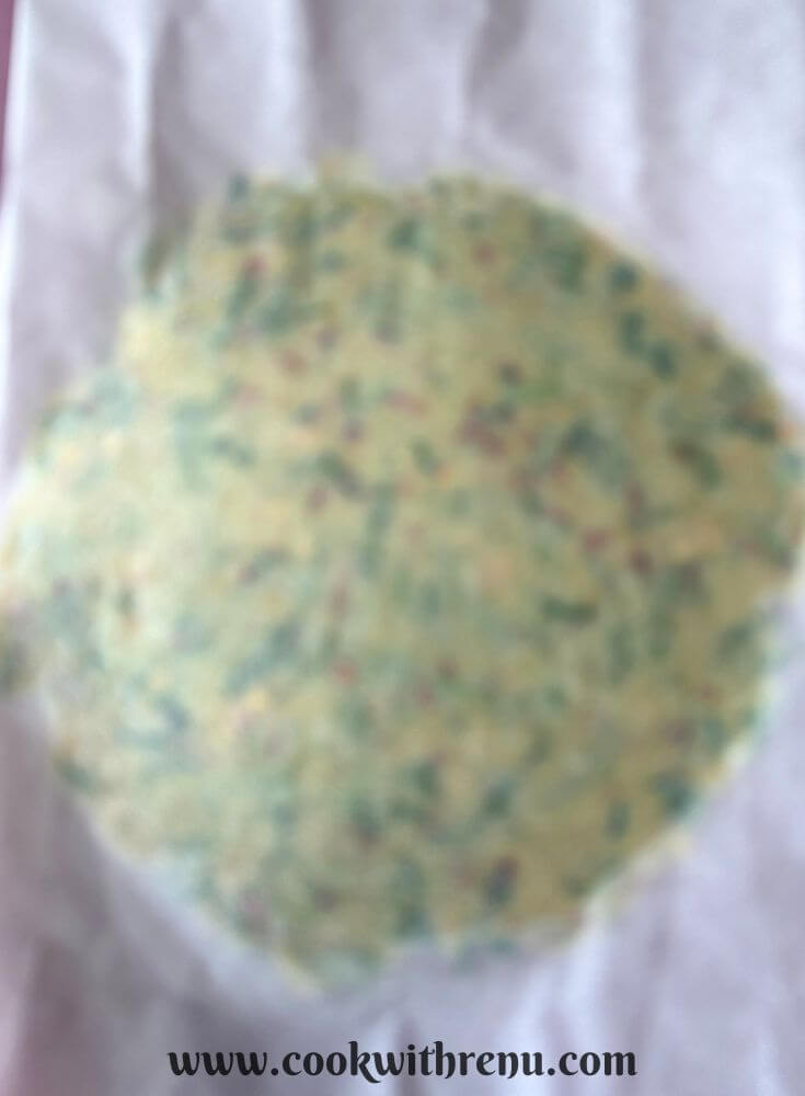 Cracker dough rolled in between a parchment paper.