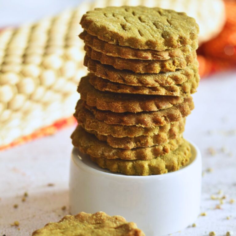 Front view of a stack of Pearl Millet Crackers on a small glass bowl.