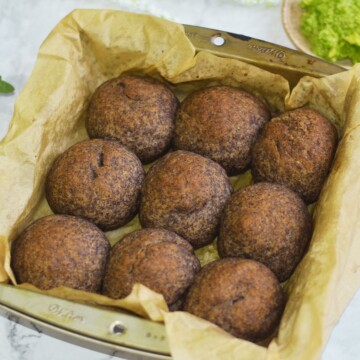 Gluten Free Buckwheat dinner rolls in a 9 inch baking tray with some guacamole on the side.