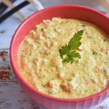 Front view of Red Pepper and Cottage Cheese Dip served in a red bowl.