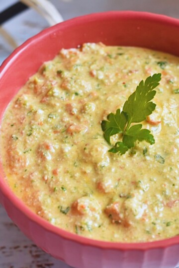 Front view of Red Pepper and Cottage Cheese Dip served in a red bowl.