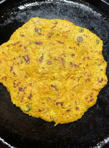 Other side of pancake is being cooked.
