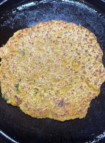 One side of pancake is being cooked.