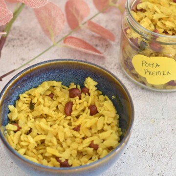 Poha made from Instant Poha premix in a blue bowl. Instant Premix seen in the background.