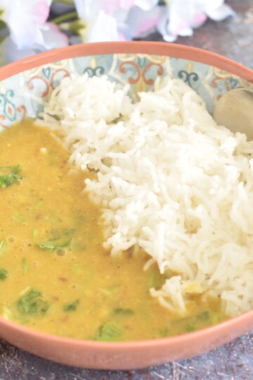 Toor Dal served in a bowl with steamed rice.