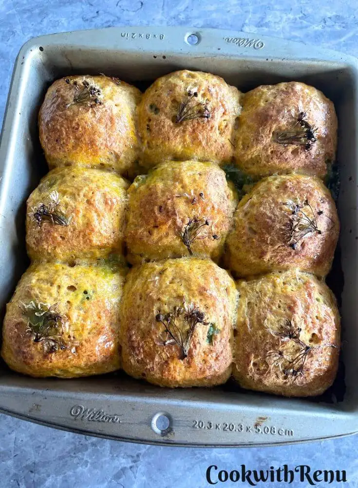 Cheesy and Spicy Wild Garlic Stuffed Spelt Rolls in a square baking tray.