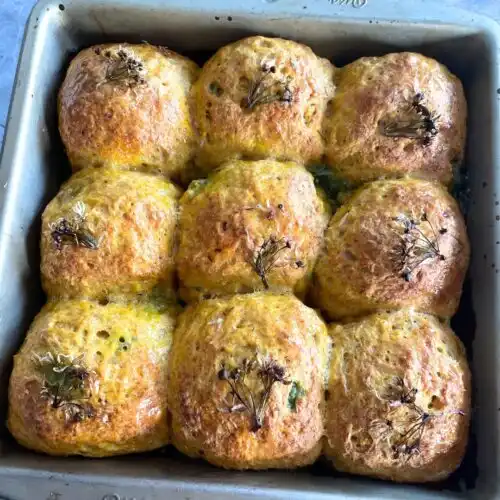 Cheesy and Spicy Wild Garlic Stuffed Spelt Rolls in a baking tray.