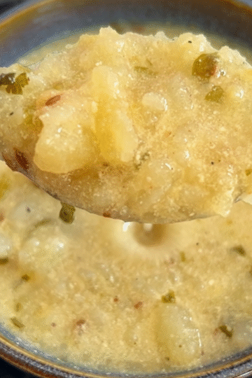 Close up look of dahi aloo seen in a spoon.