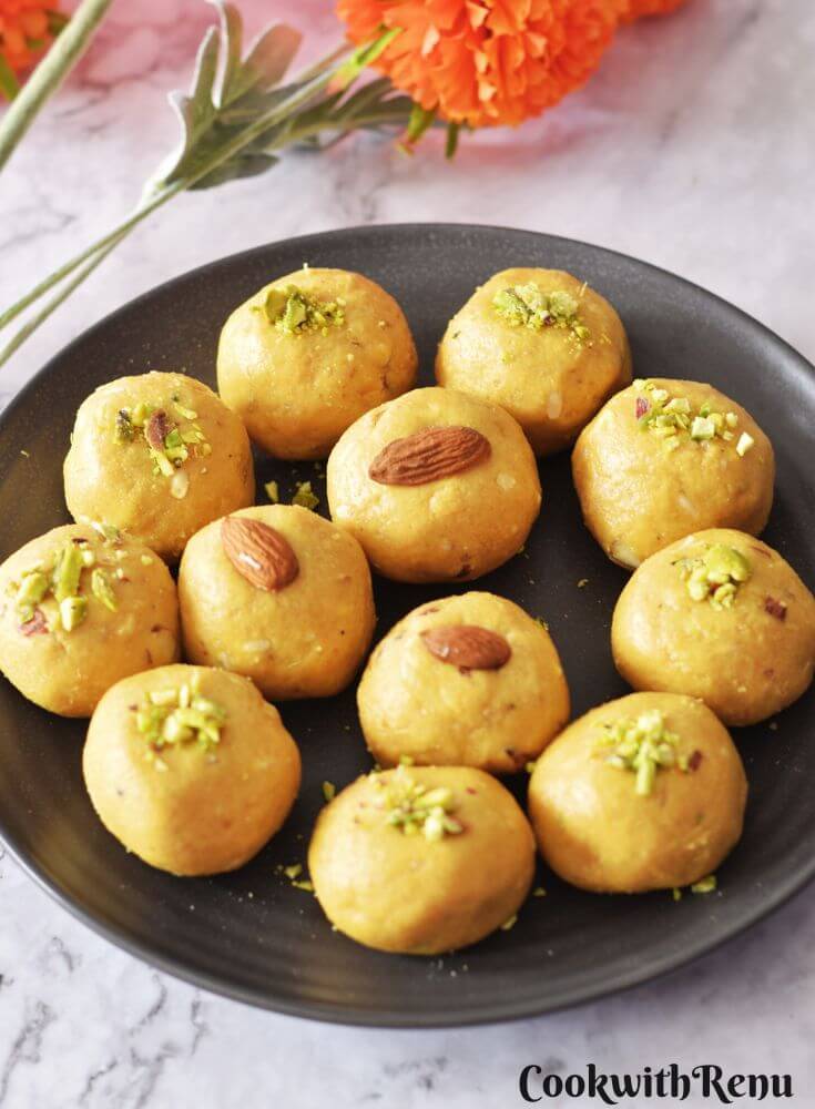 Besan Ladoo arranged in a black plate.