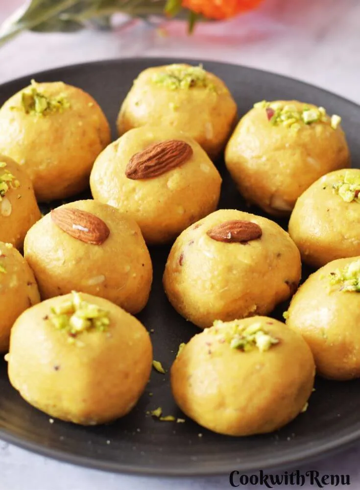 Besan Ladoo arranged in a black plate.