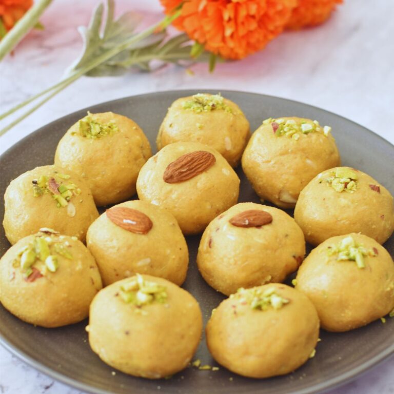 Besan Ladoo arranged in a black plate.
