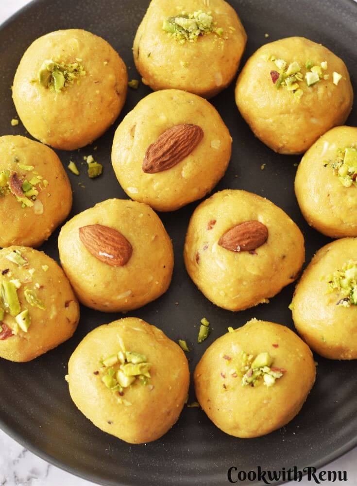 Besan Ladoo arranged in a black plate.
