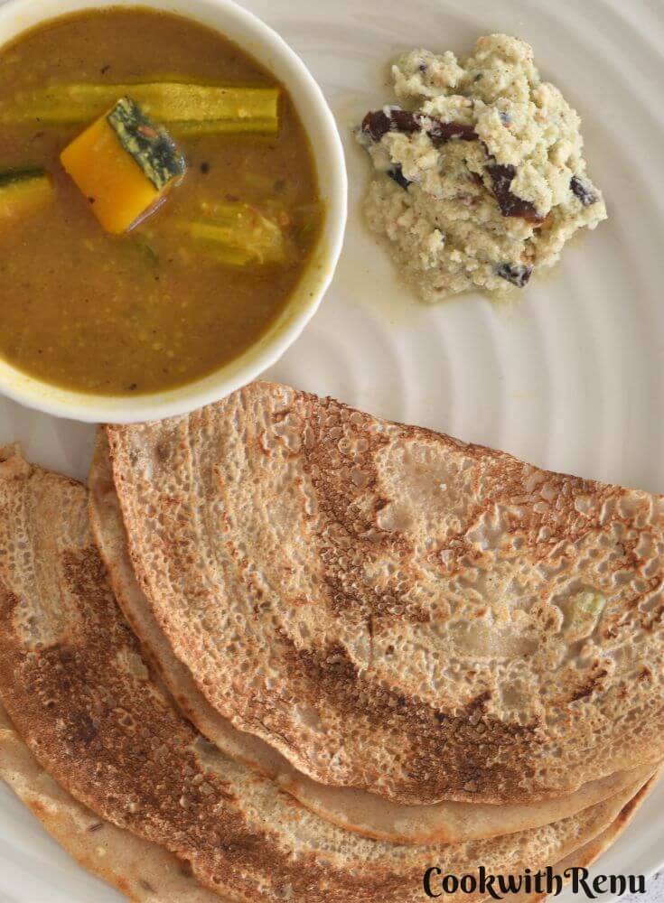 Top View of look of Khapli Wheat Dosa served in a cream plate along with chutney and sambar.