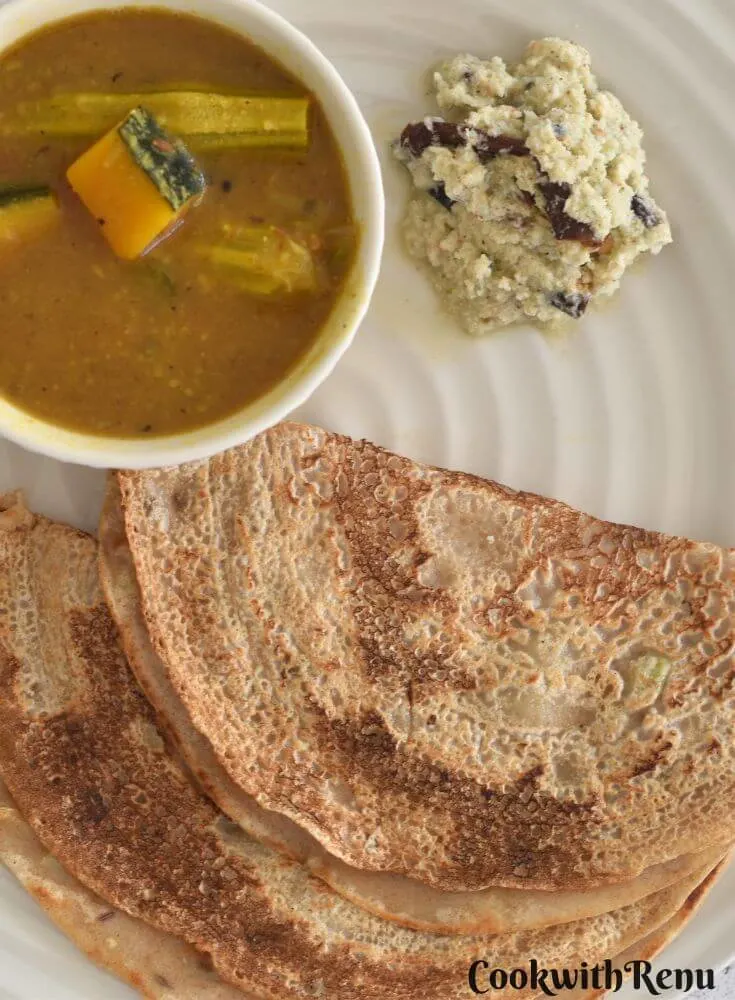 Top View of look of Khapli Wheat Dosa served in a cream plate along with chutney and sambar.