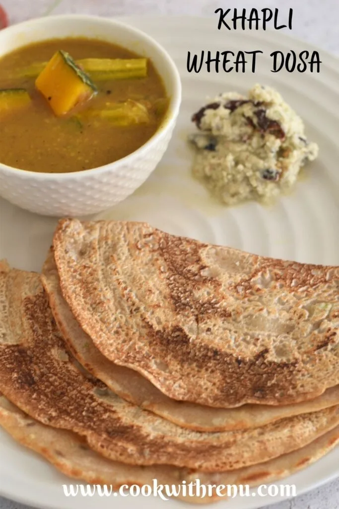 Khapli Wheat Dosa served in a cream plate along with chutney and sambar.