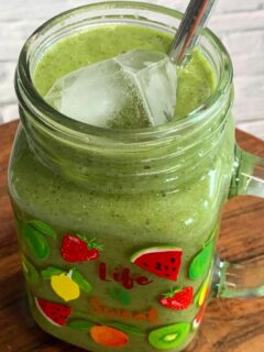 Side view of a Vegan Smoothie served in a glass along with a straw.