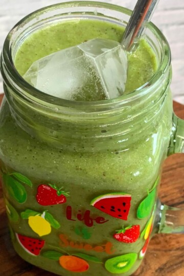 Side view of a Vegan Smoothie served in a glass along with a straw.
