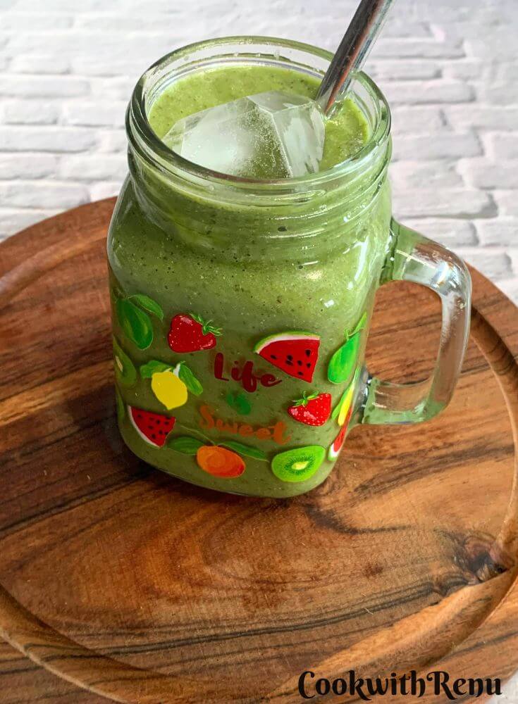 Side view of a Vegan Smoothie served in a glass along with a straw.