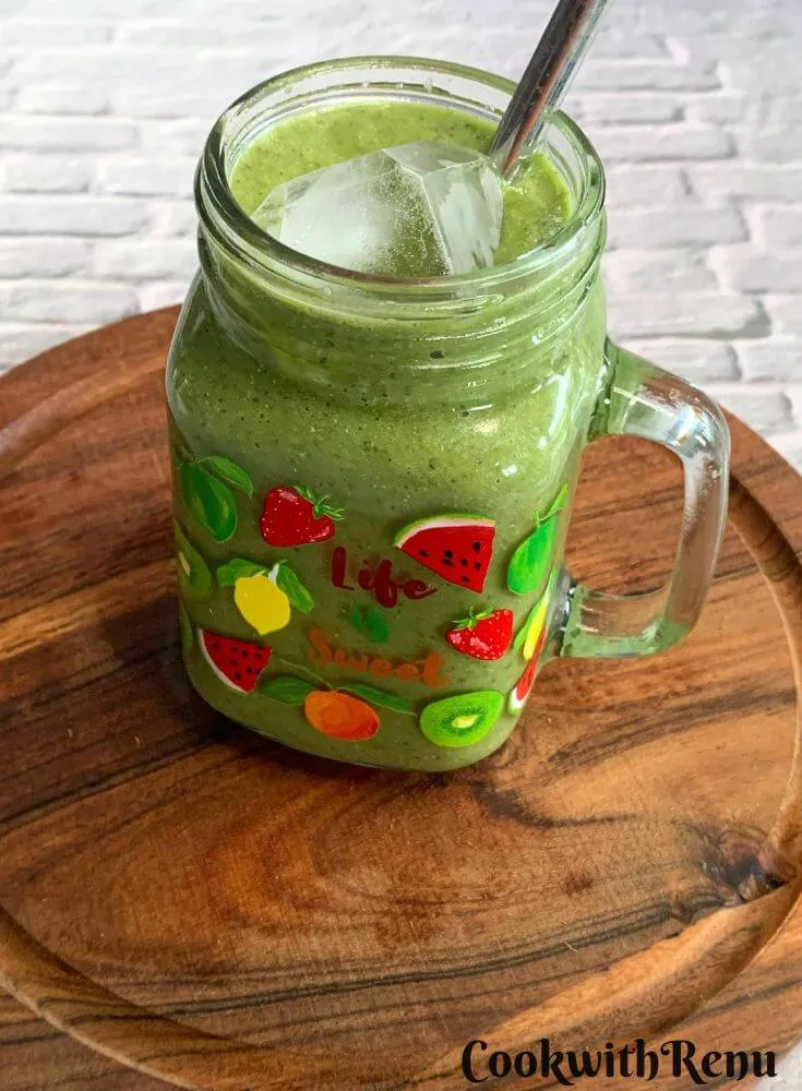 Side view of a Vegan Smoothie served in a glass along with a straw.