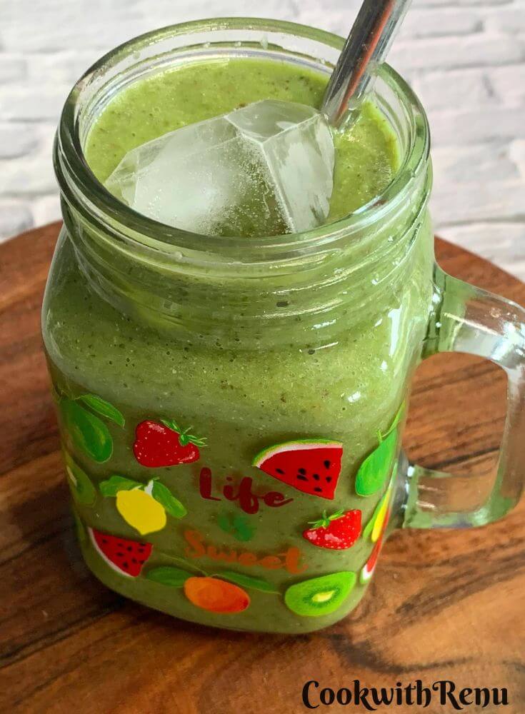 Side view of a Vegan Smoothie served in a glass along with a straw.