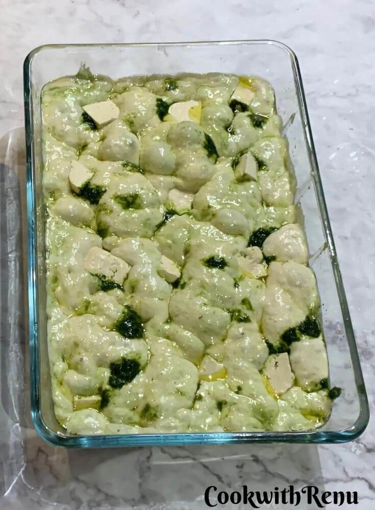 Focaccia Ready to be baked in a glass baking tray.