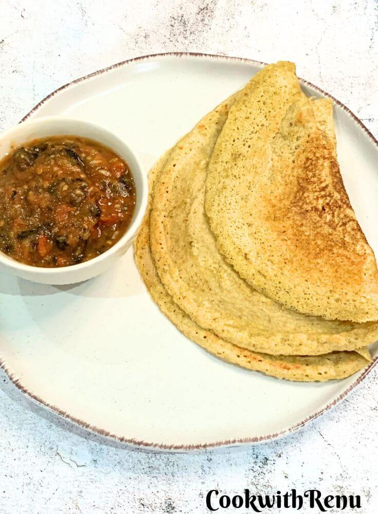 No Oil Tomato Chutney from Nagaland served in a white bowl, along with Gluten-Free Red Lentil and Quinoa Chila on a cream-coloured plate.