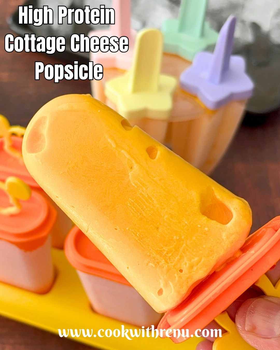 A close-up of a cottage cheese popsicle, with some popsicles in the mold in the background.