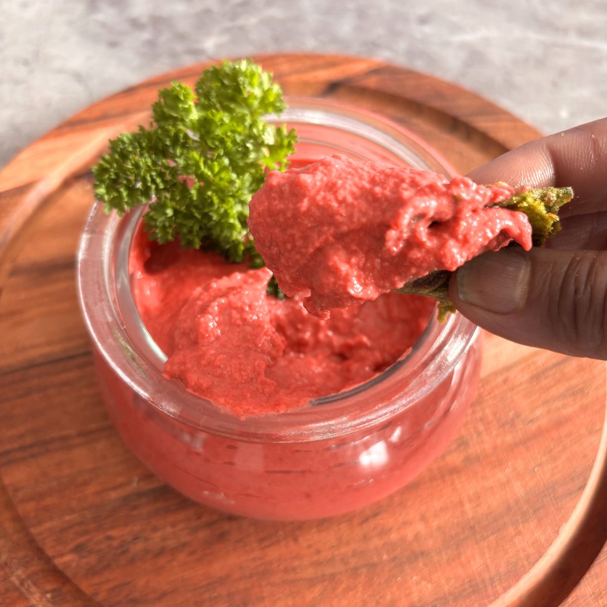 Image showing a close-up look of butter beans, beetroot hummus, dipped in a roti.