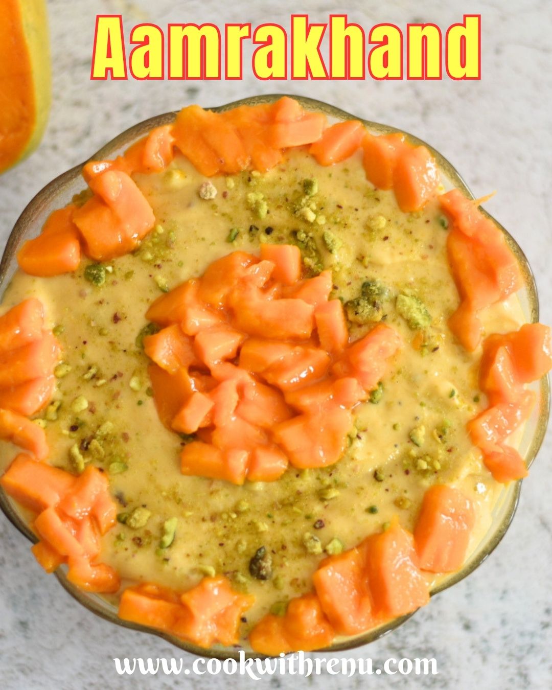 Aamrakhand served in a bowl with a generous garnish of mangoes.