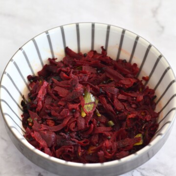 Beetroot Stir Fry served in a white bowl with grey lining.