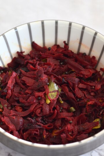 Beetroot Stir Fry served in a white bowl with grey lining.